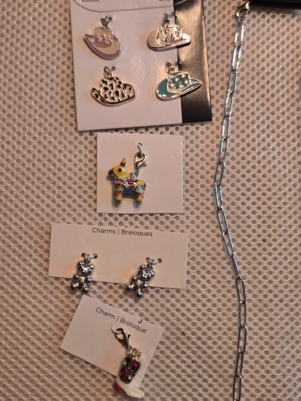 24" silver plated chain, 8 silver tone charms to create your own charm necklace.